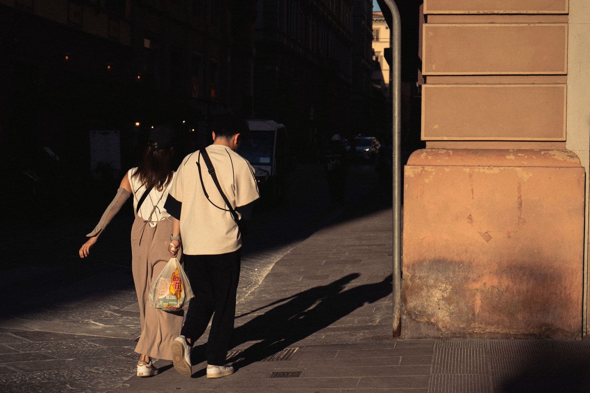 A couple walking through Florence in the evening sun