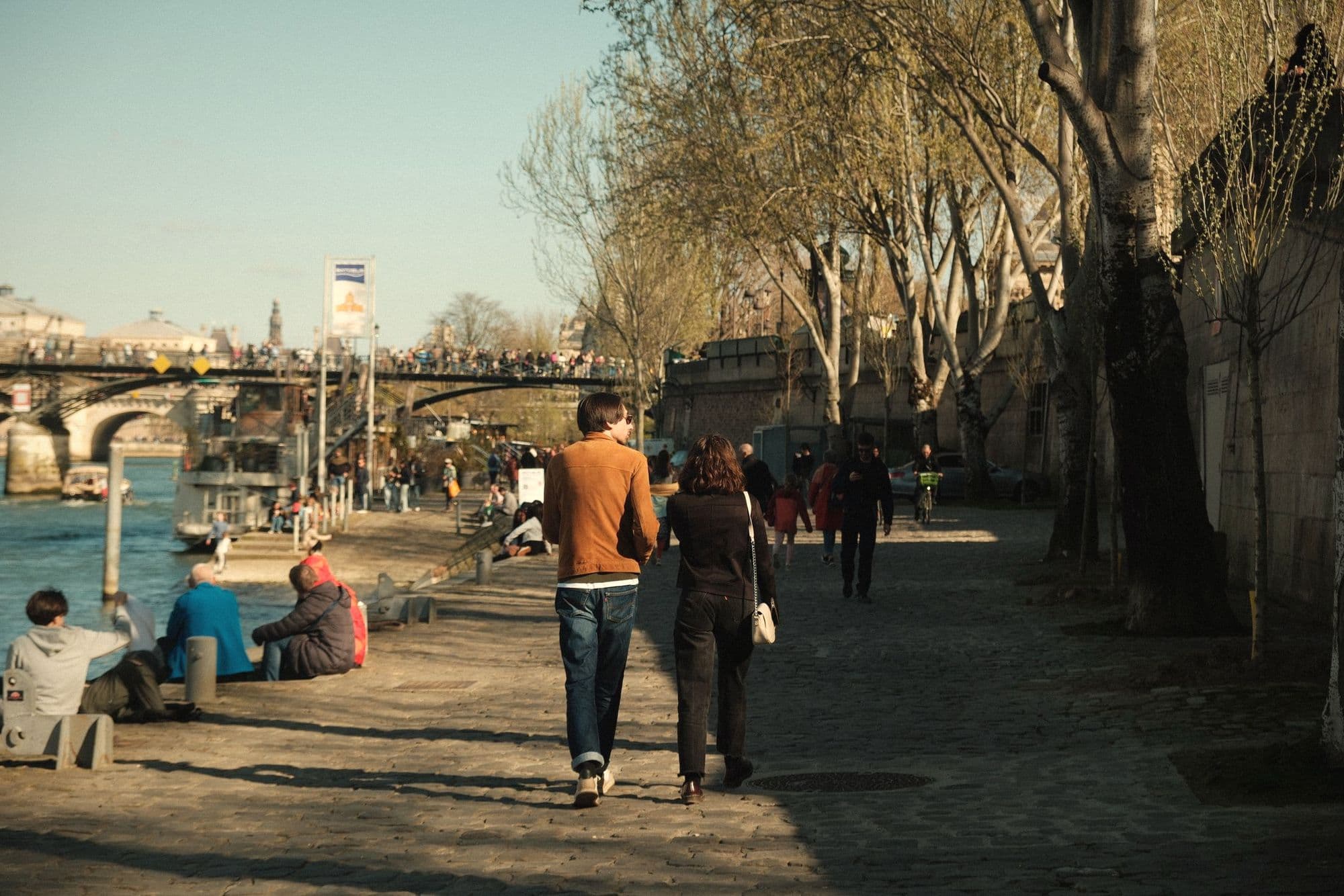 A couple strolling along the Seine in Paris